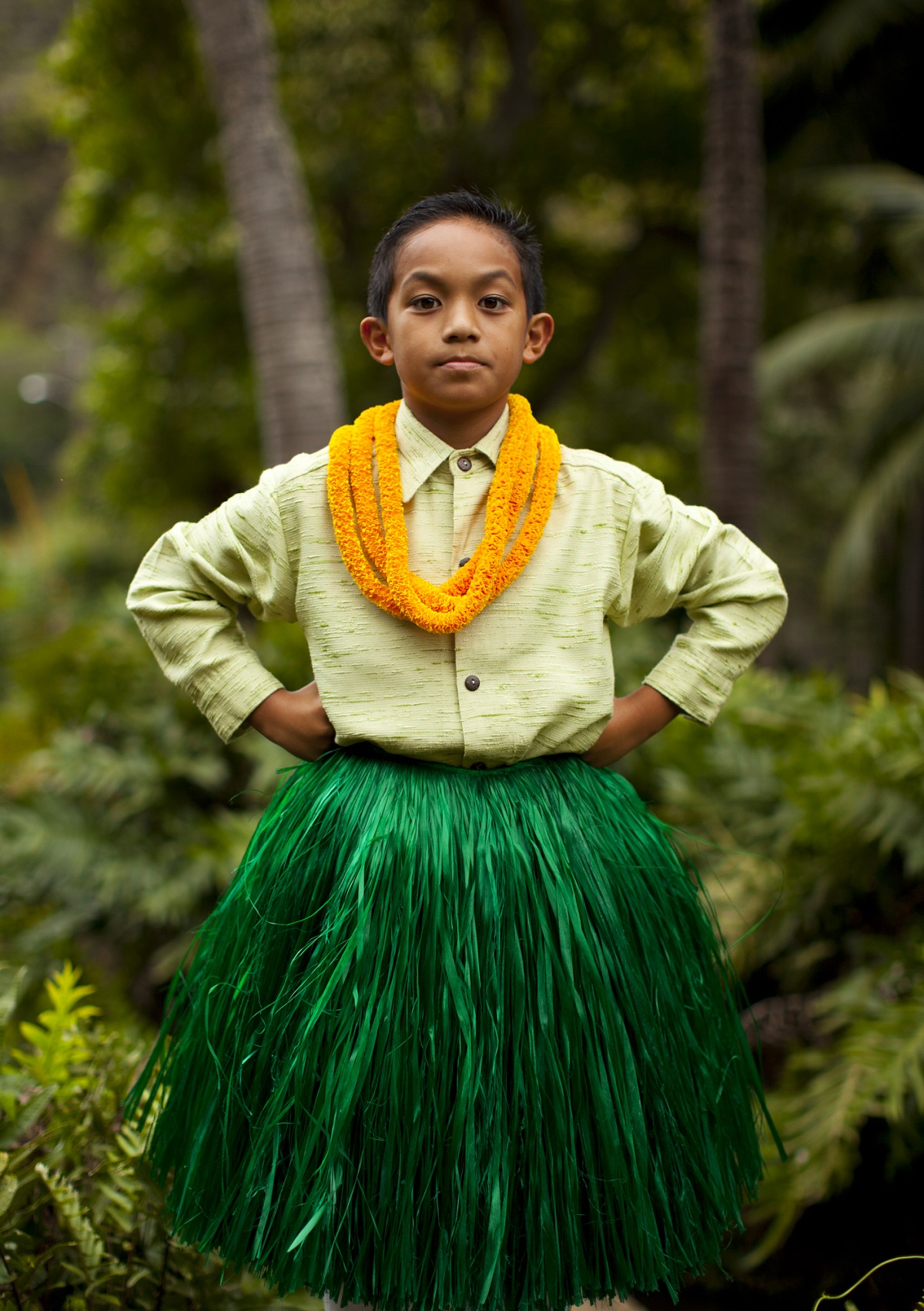 Boy in hula attire and lei