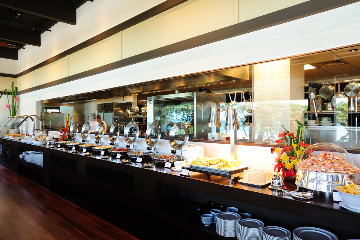 Buffet line offers a view of the kitchen where cooks busily prepare delectable dishes.